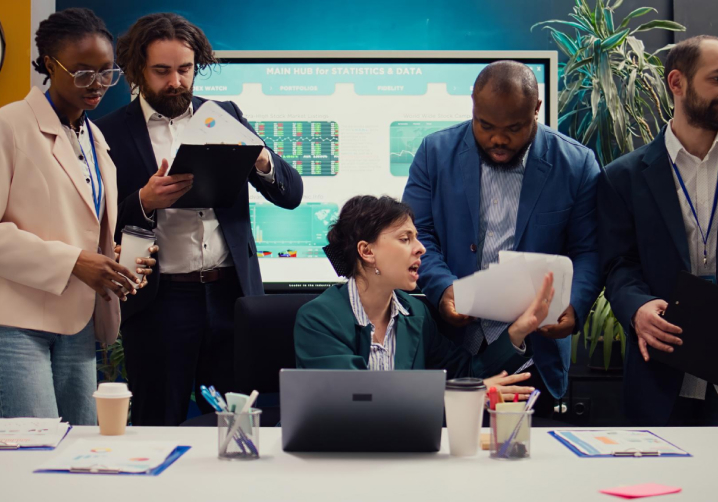 Finance team reviewing compliance documents at a business desk